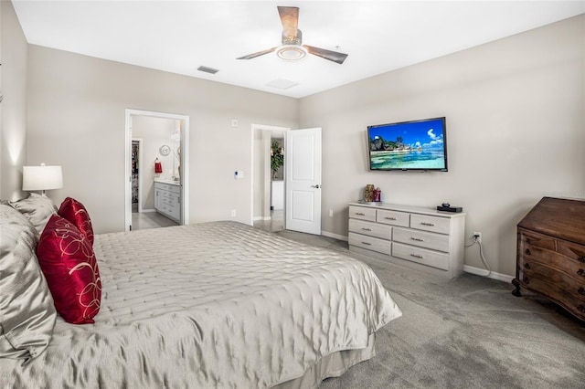 carpeted bedroom with ceiling fan and ensuite bathroom