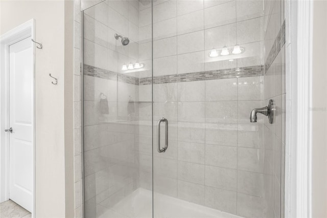 bathroom featuring a shower with door