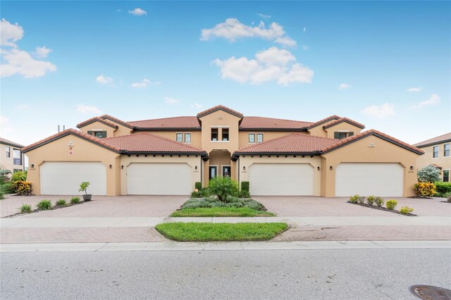 mediterranean / spanish-style home with a garage