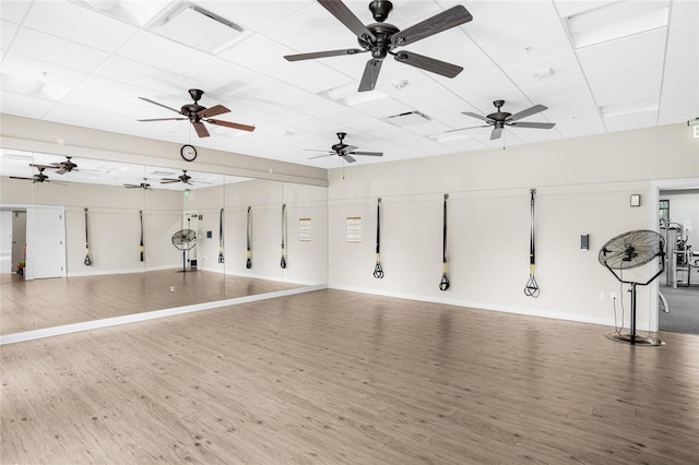 interior space featuring ceiling fan, light hardwood / wood-style flooring, and a paneled ceiling