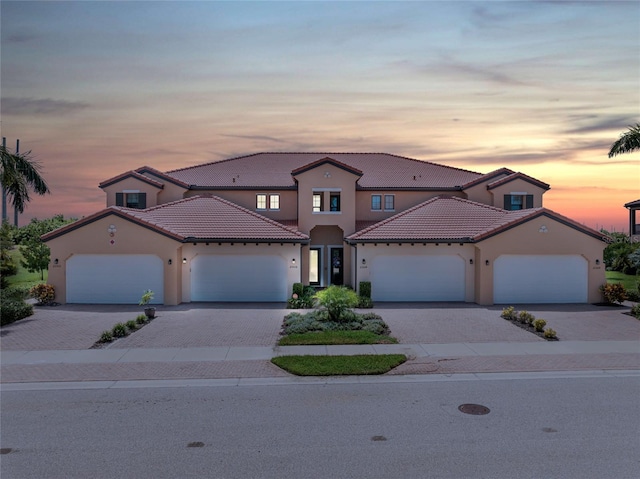 mediterranean / spanish-style home with a garage