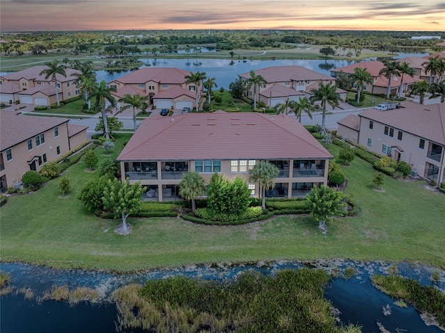 aerial view at dusk with a water view