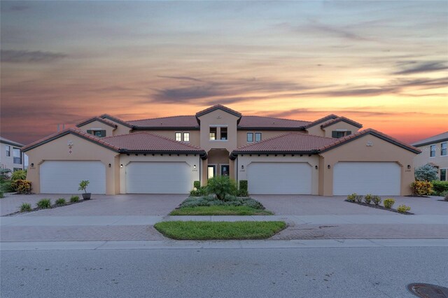 mediterranean / spanish house with a garage