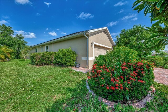 view of property exterior with a lawn and a garage