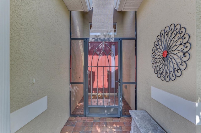 view of exterior entry featuring stucco siding