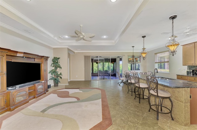 living room with recessed lighting, ceiling fan with notable chandelier, baseboards, ornamental molding, and a raised ceiling