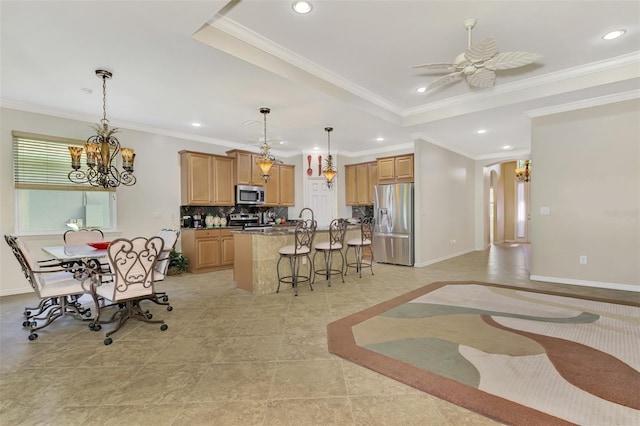 kitchen featuring a kitchen island, ornamental molding, and stainless steel appliances