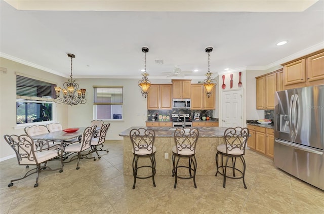 kitchen featuring backsplash, a kitchen island with sink, dark stone countertops, ornamental molding, and stainless steel appliances