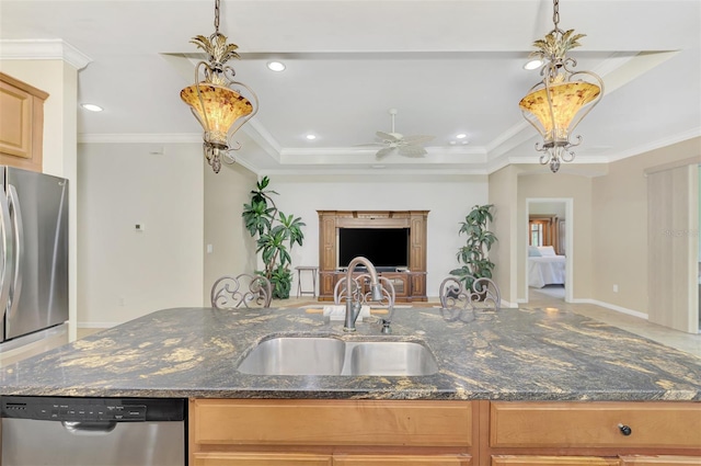 kitchen featuring appliances with stainless steel finishes, crown molding, dark stone countertops, and sink