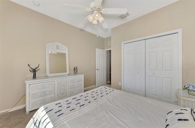 carpeted bedroom featuring a closet and ceiling fan