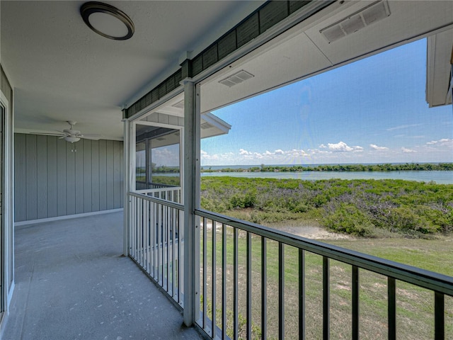 balcony with a water view and ceiling fan