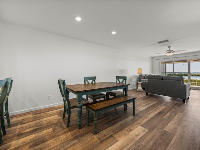 dining room with ceiling fan and dark hardwood / wood-style flooring