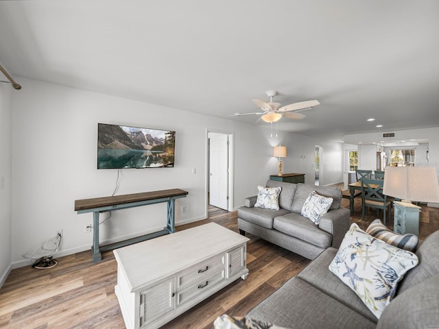 living room with hardwood / wood-style flooring and ceiling fan