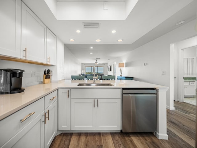 kitchen with white cabinetry, stainless steel dishwasher, kitchen peninsula, and sink