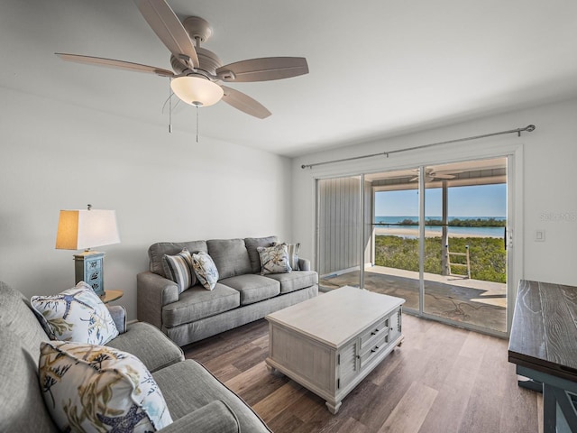 living room featuring a water view, ceiling fan, and light hardwood / wood-style floors