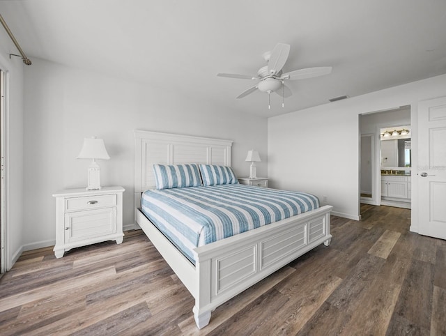 bedroom featuring multiple windows, dark hardwood / wood-style floors, connected bathroom, and ceiling fan