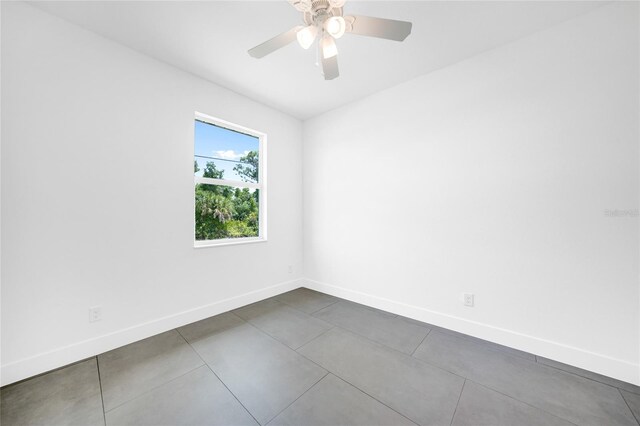 tiled empty room with ceiling fan