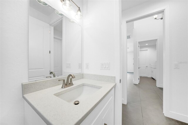 bathroom with tile patterned flooring and vanity