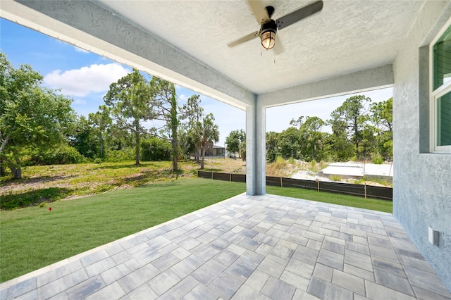 view of patio / terrace with ceiling fan and fence