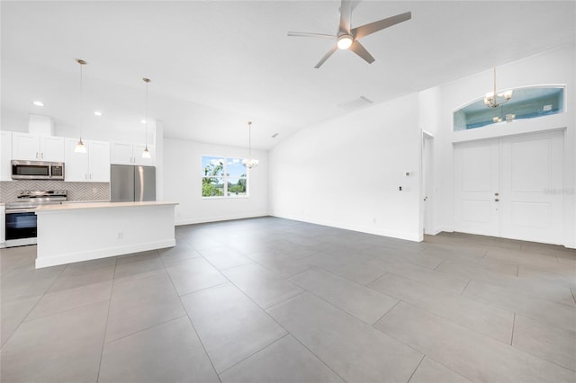 unfurnished living room with lofted ceiling, ceiling fan with notable chandelier, and light tile patterned floors