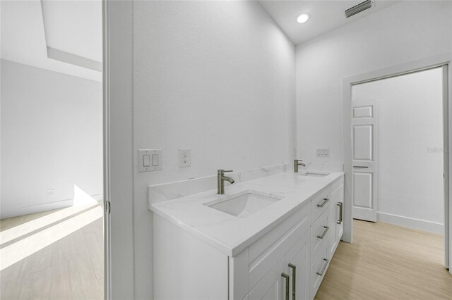 9262 Genesee St, Port Charlotte, FL 33981 - bathroom featuring double vanity, wood finished floors, and recessed lighting