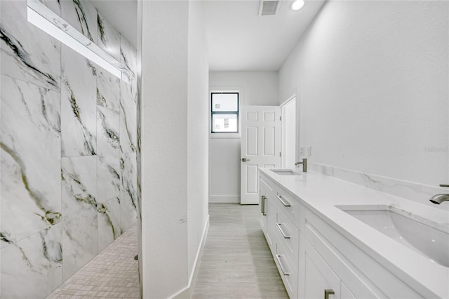 9262 Genesee St, Port Charlotte, FL 33981 - bathroom with a marble finish shower, double vanity, and wood finished floors