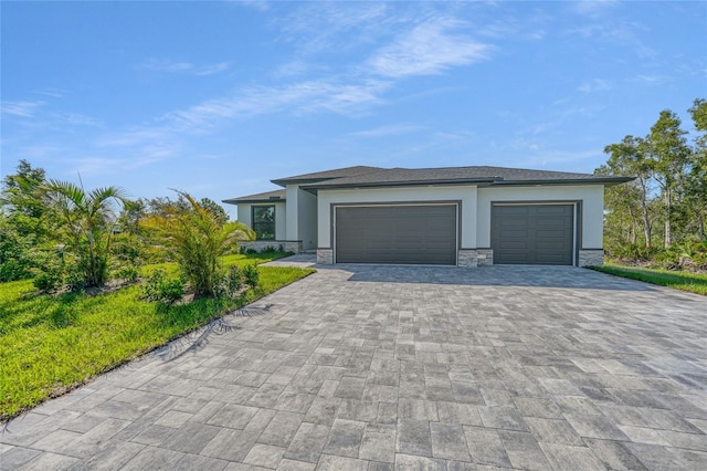 9262 Genesee St, Port Charlotte, FL 33981 - prairie-style home featuring decorative driveway, stucco siding, an attached garage, and stone siding
