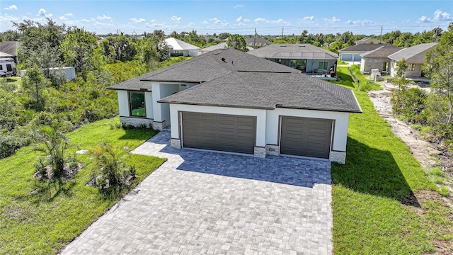 9262 Genesee St, Port Charlotte, FL 33981 - view of front of house featuring a garage, stucco siding, decorative driveway, a shingled roof, and a front yard