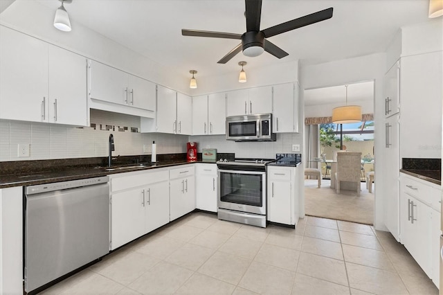 kitchen featuring sink, ceiling fan, white cabinetry, stainless steel appliances, and tasteful backsplash