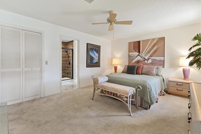 bedroom featuring ceiling fan, light carpet, a textured ceiling, and a closet