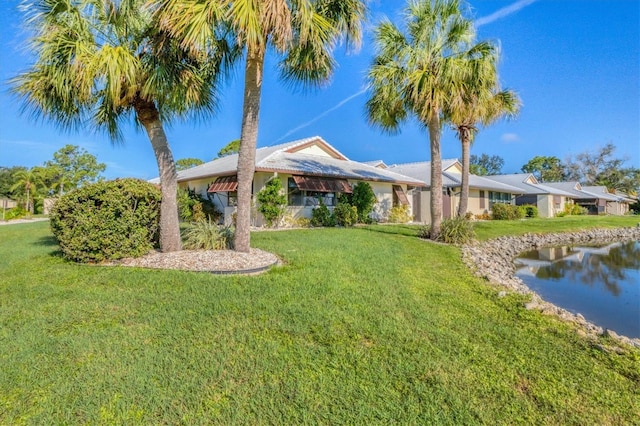 single story home with a water view and a front yard