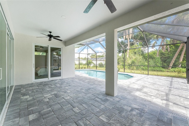 view of pool with ceiling fan, a lanai, and a patio