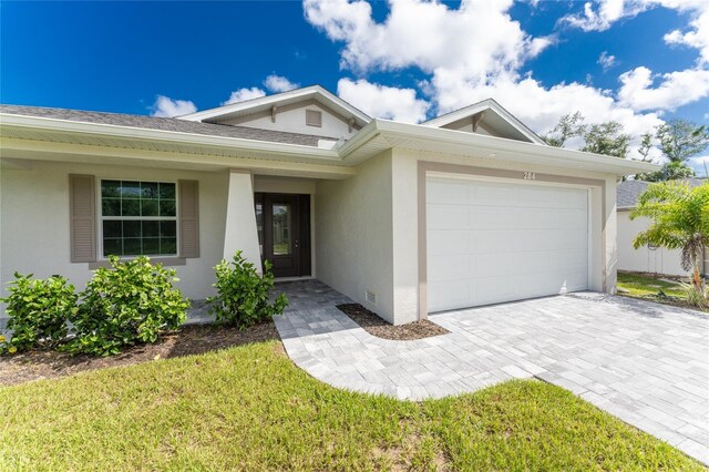 ranch-style home with a front yard and a garage