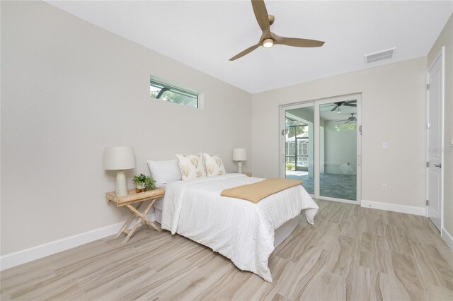 bedroom featuring light hardwood / wood-style floors, ceiling fan, and access to exterior