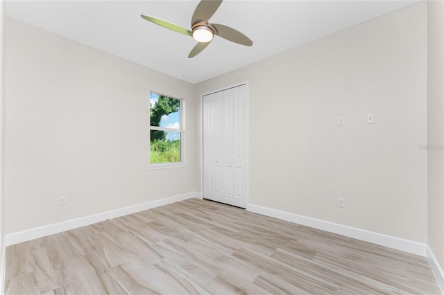 unfurnished bedroom featuring light wood-type flooring, a closet, and ceiling fan