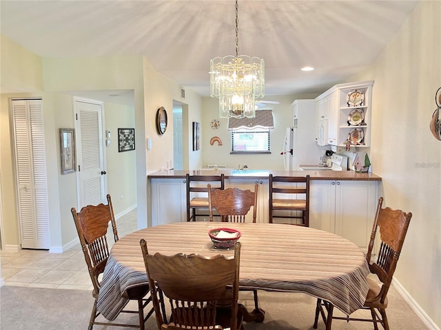 dining room with light tile patterned flooring and a chandelier