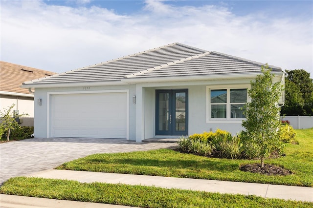 view of front of home with a garage and a front lawn