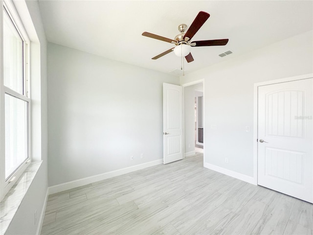 unfurnished bedroom with light wood-type flooring and ceiling fan