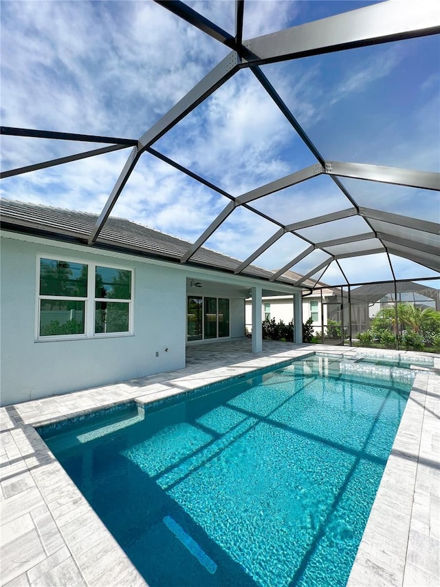 view of swimming pool with a lanai and a patio