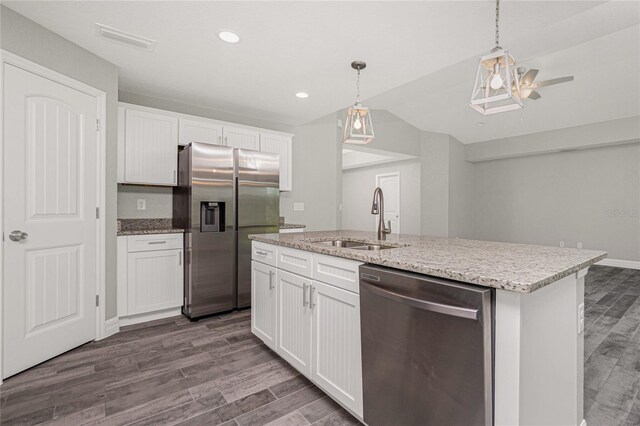 kitchen featuring stainless steel appliances, sink, wood-type flooring, and white cabinets