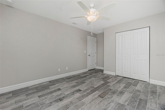 unfurnished bedroom featuring a closet, ceiling fan, and hardwood / wood-style flooring