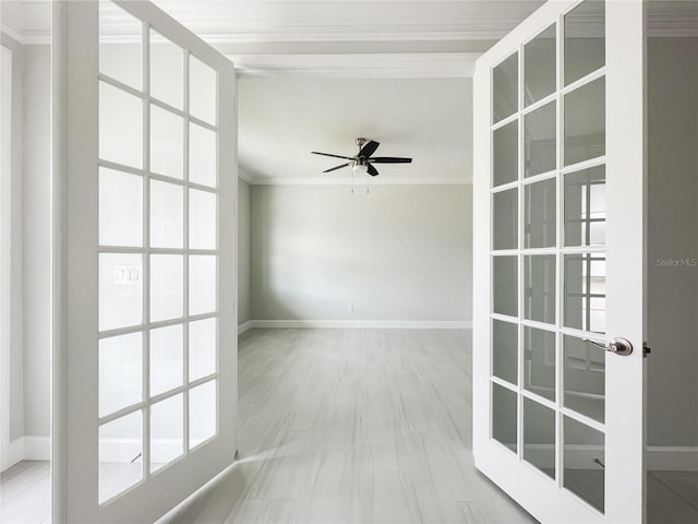 empty room featuring ceiling fan, ornamental molding, and french doors