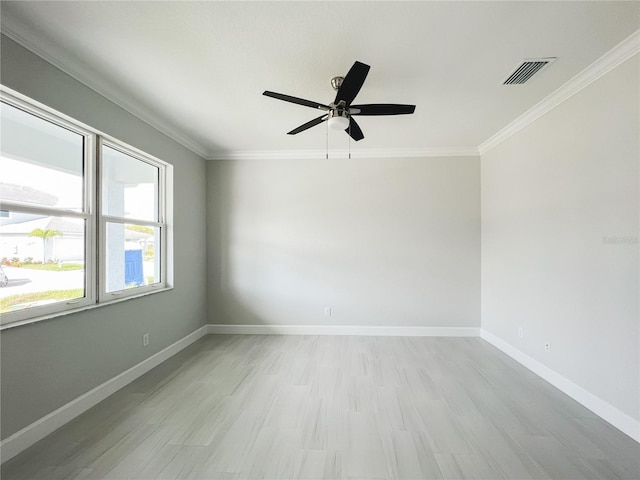 empty room with crown molding, ceiling fan, and light hardwood / wood-style floors