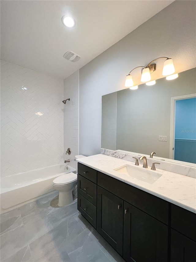 full bathroom featuring tiled shower / bath combo, vanity, toilet, and tile patterned floors