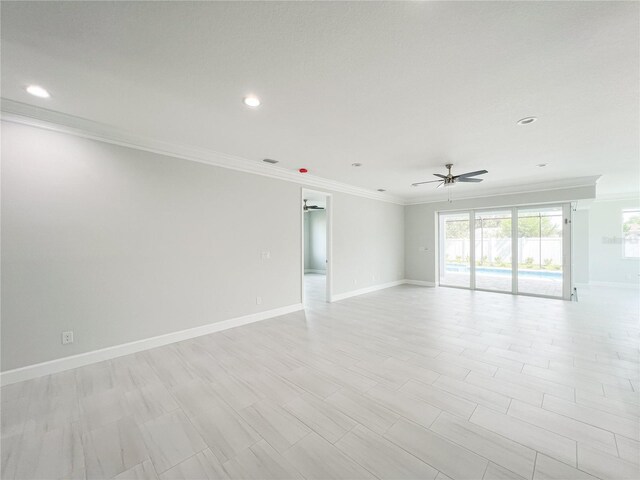 empty room with ceiling fan and ornamental molding