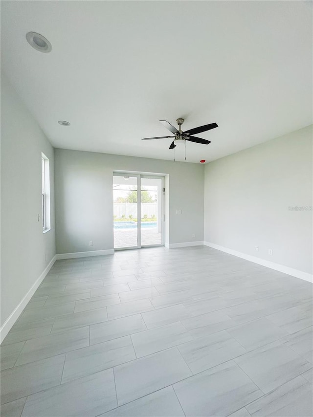 spare room featuring light tile patterned flooring and ceiling fan