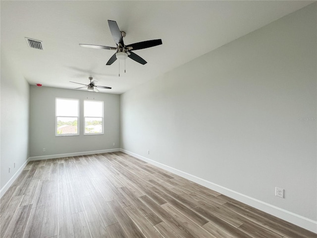 empty room with light wood-type flooring and ceiling fan