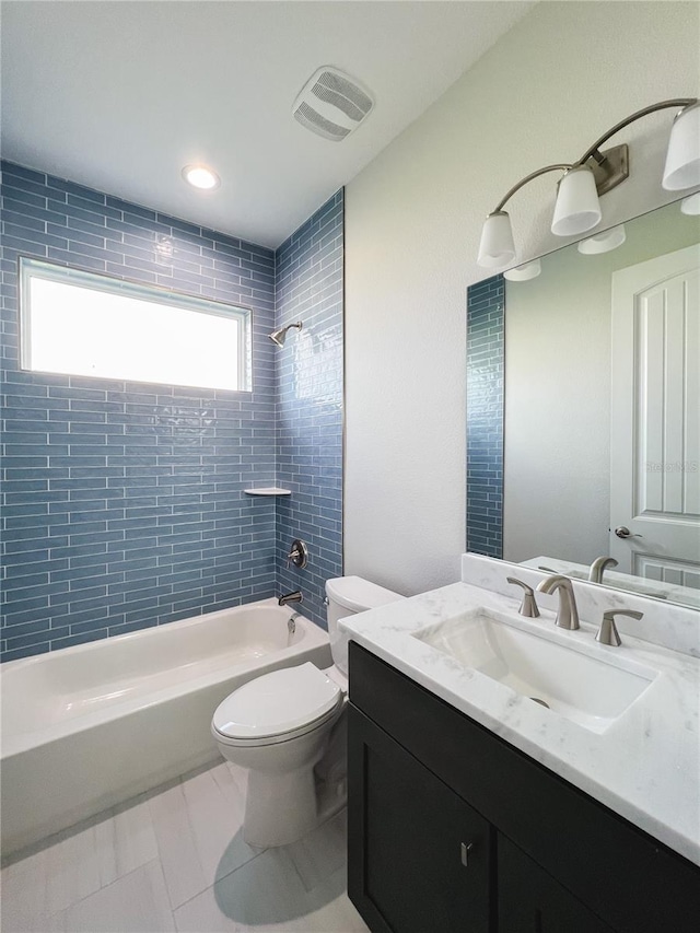 full bathroom with vanity, toilet, tiled shower / bath combo, and tile patterned floors