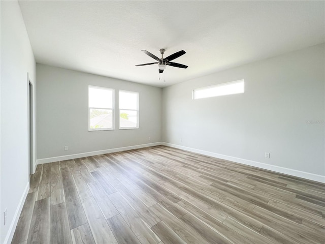 empty room featuring light hardwood / wood-style flooring and ceiling fan