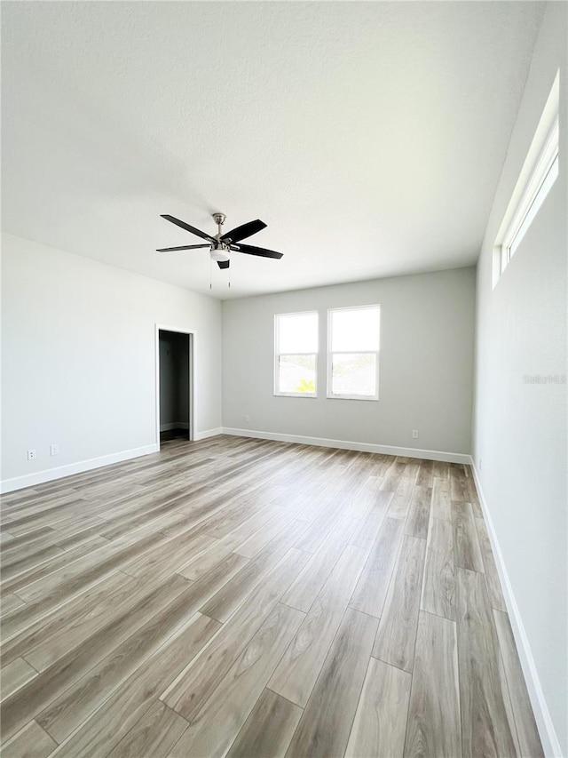 unfurnished living room with ceiling fan and light hardwood / wood-style floors